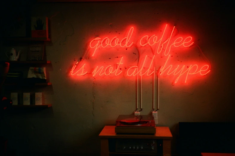 a neon sign that says good coffee is not all hype, an album cover, unsplash contest winner, demna gvasalia, brightly lit room, taken in the 2000s, no cropping