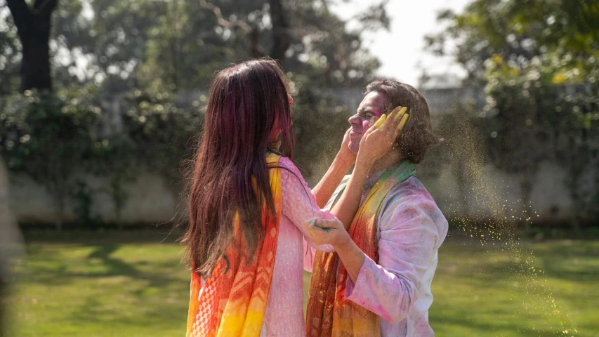 a couple of women standing next to each other, pexels contest winner, bengal school of art, splashes of colors, celebrating, on a sunny day, cottagecore hippie