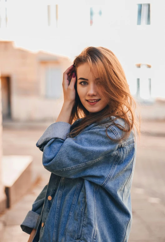a woman in a denim jacket talking on a cell phone, a picture, trending on pexels, renaissance, attractive brown hair woman, anna nikonova aka newmilky, confident pose, goldenhour