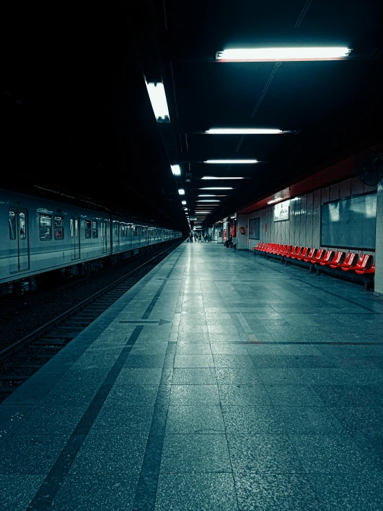 a train pulling into a train station at night, inspired by Elsa Bleda, unsplash contest winner, postminimalism, benches, empty floor, ultra realistic 8k octan photo, today\'s featured photograph 4k