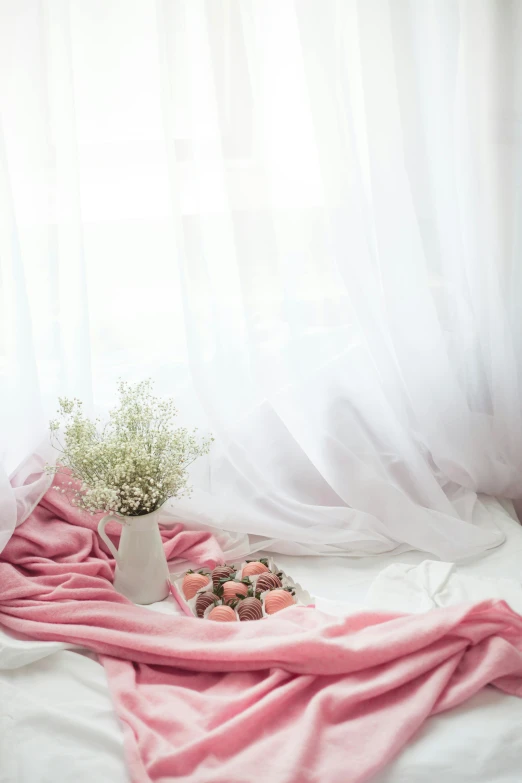 a white bed topped with a pink blanket next to a window, a still life, by Basuki Abdullah, unsplash contest winner, romanticism, candies, soft translucent fabric folds, white backdrop, bouquets