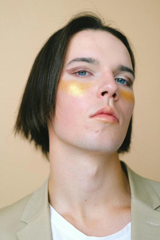 a close up of a person with makeup on, by Attila Meszlenyi, smooth gold skin, a young man, prismatic highlights, julian ope