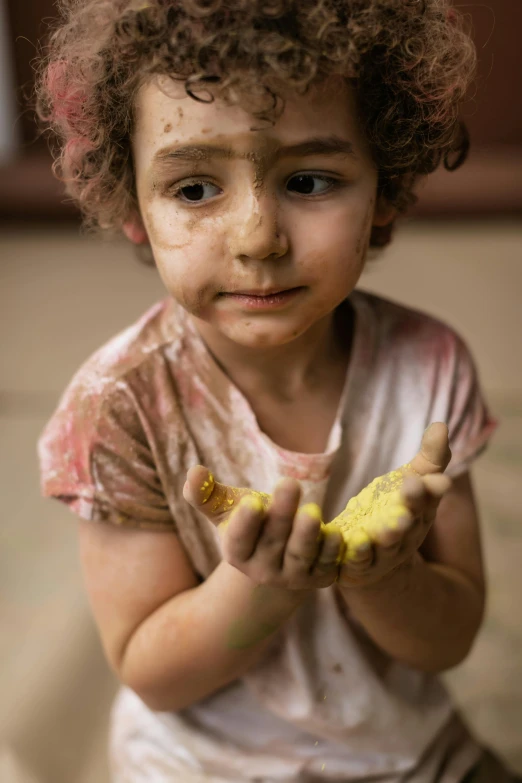 a little girl with messy hair holding a banana, by irakli nadar, pexels contest winner, process art, fingerprints on clay, turkey, ochre, multi - coloured