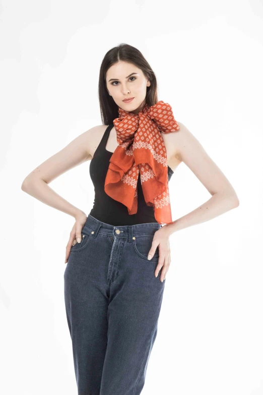 a woman standing with her hands on her hips, a portrait, shutterstock, patterned scarf, orange halter top, red shirt brown pants, white bg