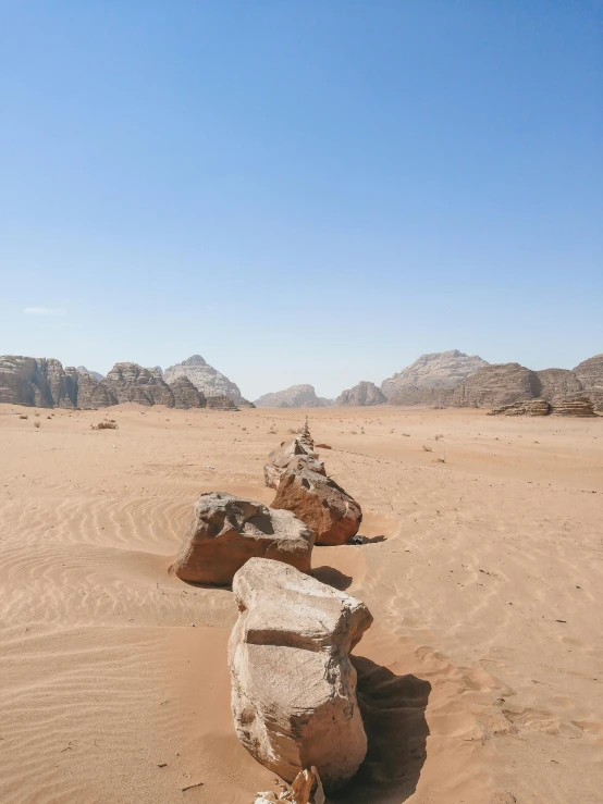 a rock formation in the middle of a desert, pexels contest winner, dau-al-set, they might be crawling, shallan davar, red!! sand, valley in the distance