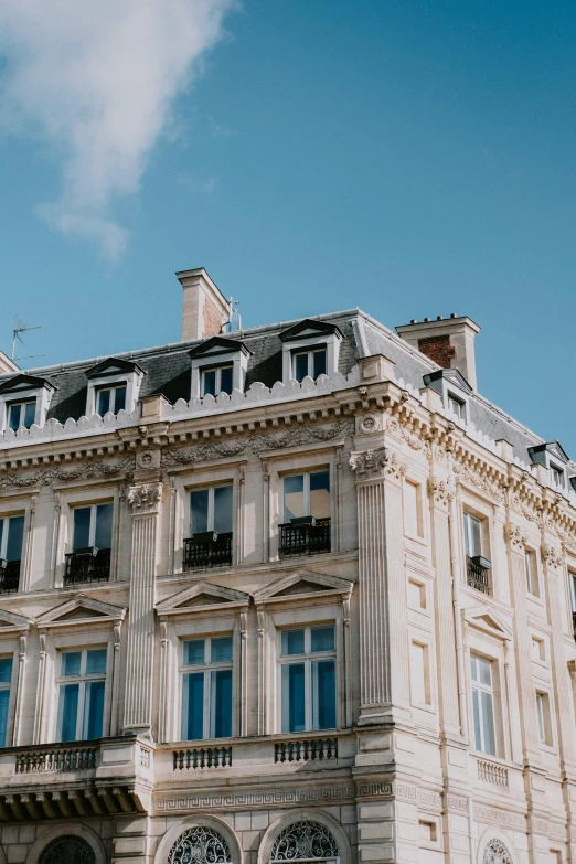 a tall building sitting on the side of a street, pexels contest winner, neoclassicism, normandy, rooftop, mansion, directoire style