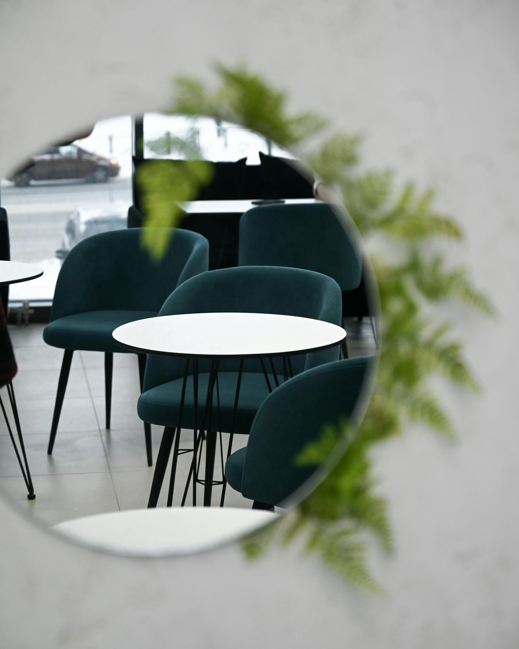 a round mirror sitting on the side of a wall, inspired by Constantin Hansen, trending on unsplash, concrete art, cafe tables, black and green scheme, 7 0 mm photo, white background and fill