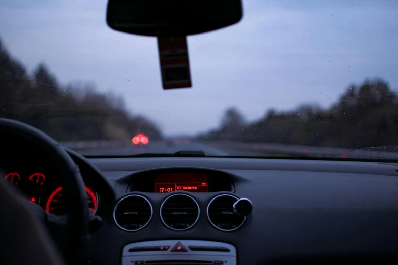 a close up of the dashboard of a car, unsplash, realism, evening at dusk, fan favorite, pov from rear, pov