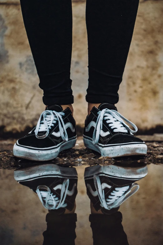 a person standing on top of a puddle of water, pexels contest winner, hyperrealism, sneaker shoes, mirrored, black and silver, teenage