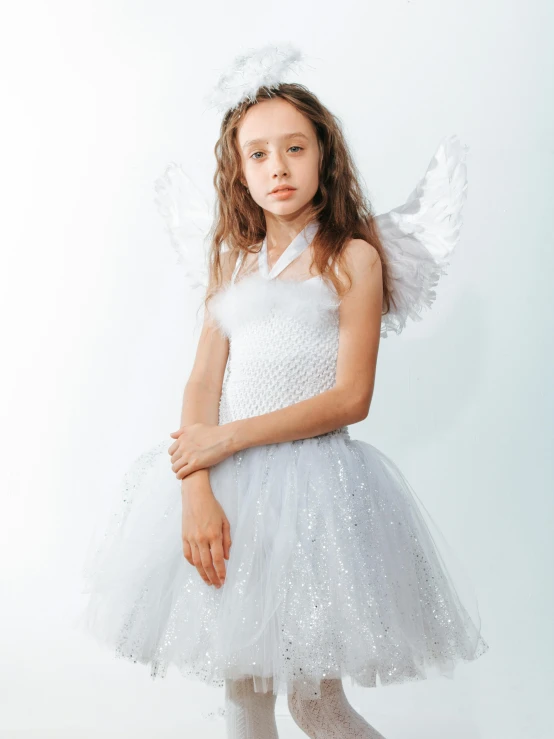 a little girl wearing a white dress and angel wings, grey and silver, product introduction photo, fae teenage girl, medium