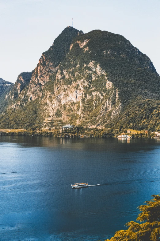 a boat in the middle of a large body of water, by Sebastian Spreng, pexels contest winner, mountainous landscape, svend smital, flat lay, summer light