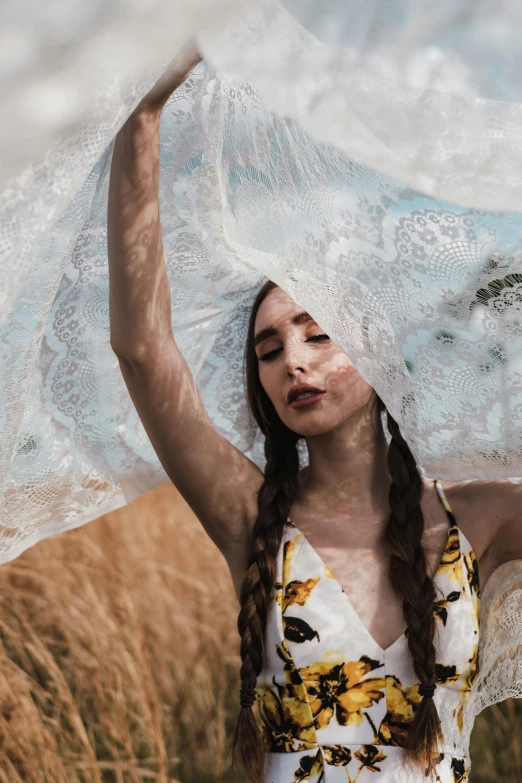 a woman standing in a field with a veil over her head, unsplash contest winner, art photography, photo of a hand jewellery model, patterned clothing, clouds of vivid horse-hair wigs, covered in white flour