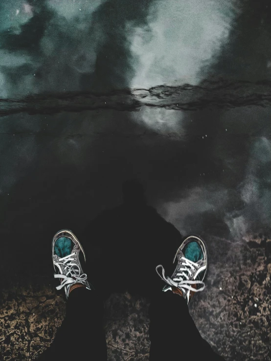 a person standing in front of a body of water, inspired by Elsa Bleda, sneaker photo, dark green water, ((oversaturated)), reflective floor