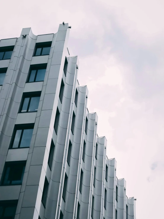 a tall white building with lots of windows, unsplash, brutalism, trending on vsco, grey skies, pearly sky, ilustration