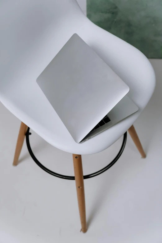 a white chair with a laptop on top of it, by Carey Morris, trending on pexels, made of high tech materials, handcrafted, matte surface, upper body image