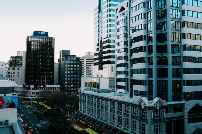 a city street filled with lots of tall buildings, a screenshot, by Lee Loughridge, unsplash contest winner, hurufiyya, new zealand, overwatch building, in a city with a rich history, panoramic shot