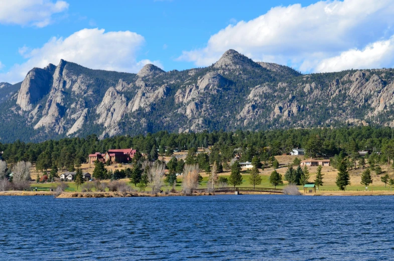 a large body of water with a mountain in the background, evergreen, buildings, colorado, parks and monuments