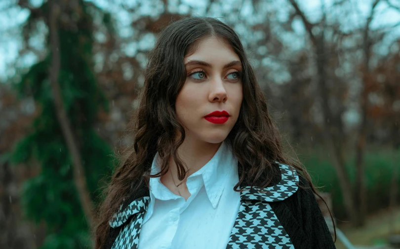a woman in a white shirt and black and white coat, inspired by Elsa Bleda, pexels contest winner, art nouveau, red velvet, lorde, she looks like a mix of grimes, in a park