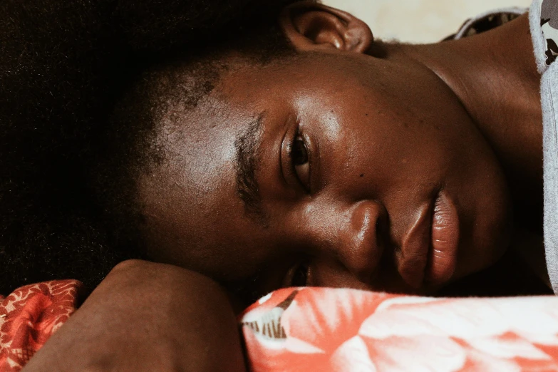 a close up of a person laying on a bed, by Carey Morris, trending on pexels, happening, black girl, adut akech, laura zalenga, thumbnail