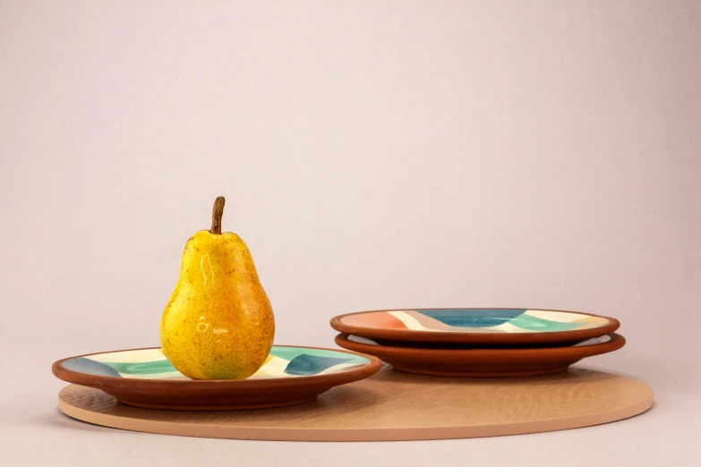 a pear sitting on a plate next to another plate, inspired by Giorgio Morandi, featured on dribble, cloisonnism, multi - coloured, striped, terracotta, 2 1 0 mm