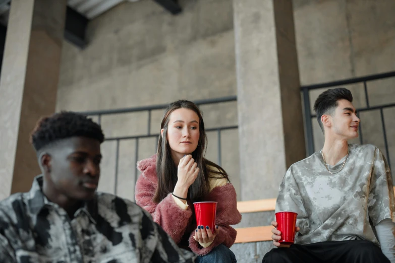 a group of young people sitting next to each other, by Emma Andijewska, trending on pexels, renaissance, awkwardly holding red solo cup, 15081959 21121991 01012000 4k, looking across the shoulder, student