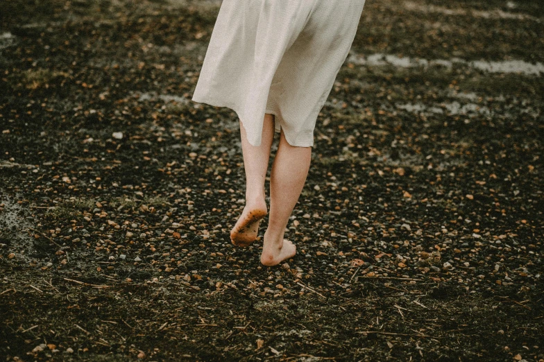 a woman in a white dress holding an umbrella, by Anna Boch, pexels contest winner, renaissance, feet on the ground, brown clothes, footprints, slightly pixelated