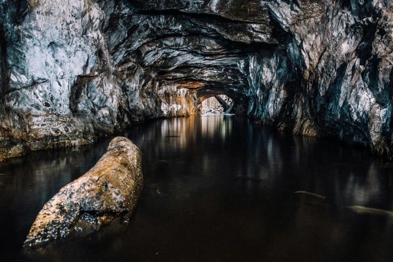 a large rock sitting in the middle of a river, by Jesper Knudsen, unsplash contest winner, art nouveau, underground tunnel, ultra 4k, speleothems, thumbnail
