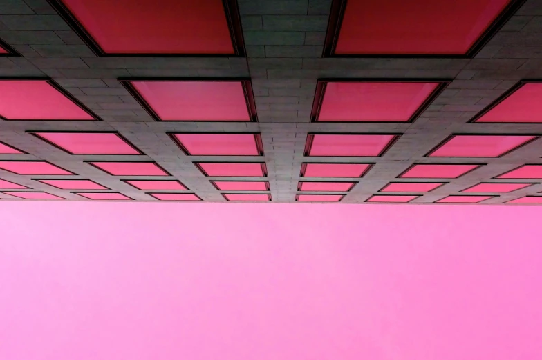 a person sitting on a bench in front of a pink wall, an album cover, inspired by David Chipperfield, unsplash contest winner, brutalism, office ceiling panels, 3/4 view from below, glimpse of red, canopy