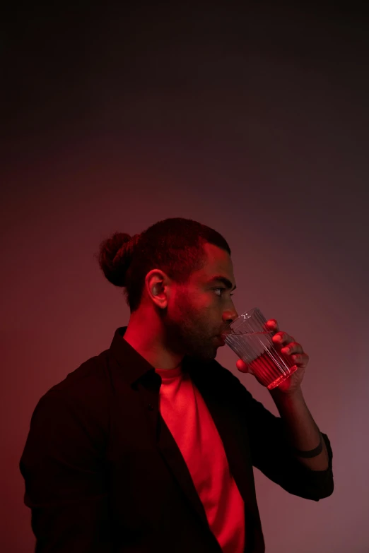 a man in a suit drinking a glass of water, an album cover, by Cosmo Alexander, pexels, renaissance, red lighting on their faces, light stubble with red shirt, dr zeus, profile portrait
