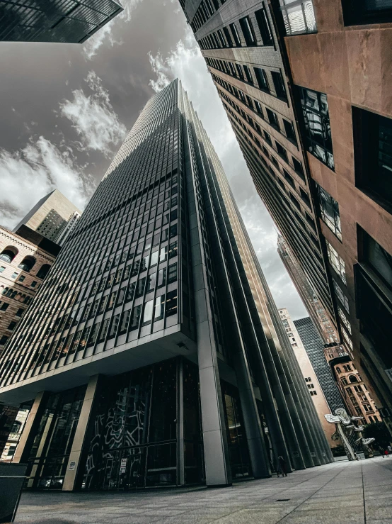 a very tall building sitting in the middle of a city, by Adam Rex, pexels contest winner, modernism, sins inc skyscraper front, dramatic angle, high quality image, multiple stories