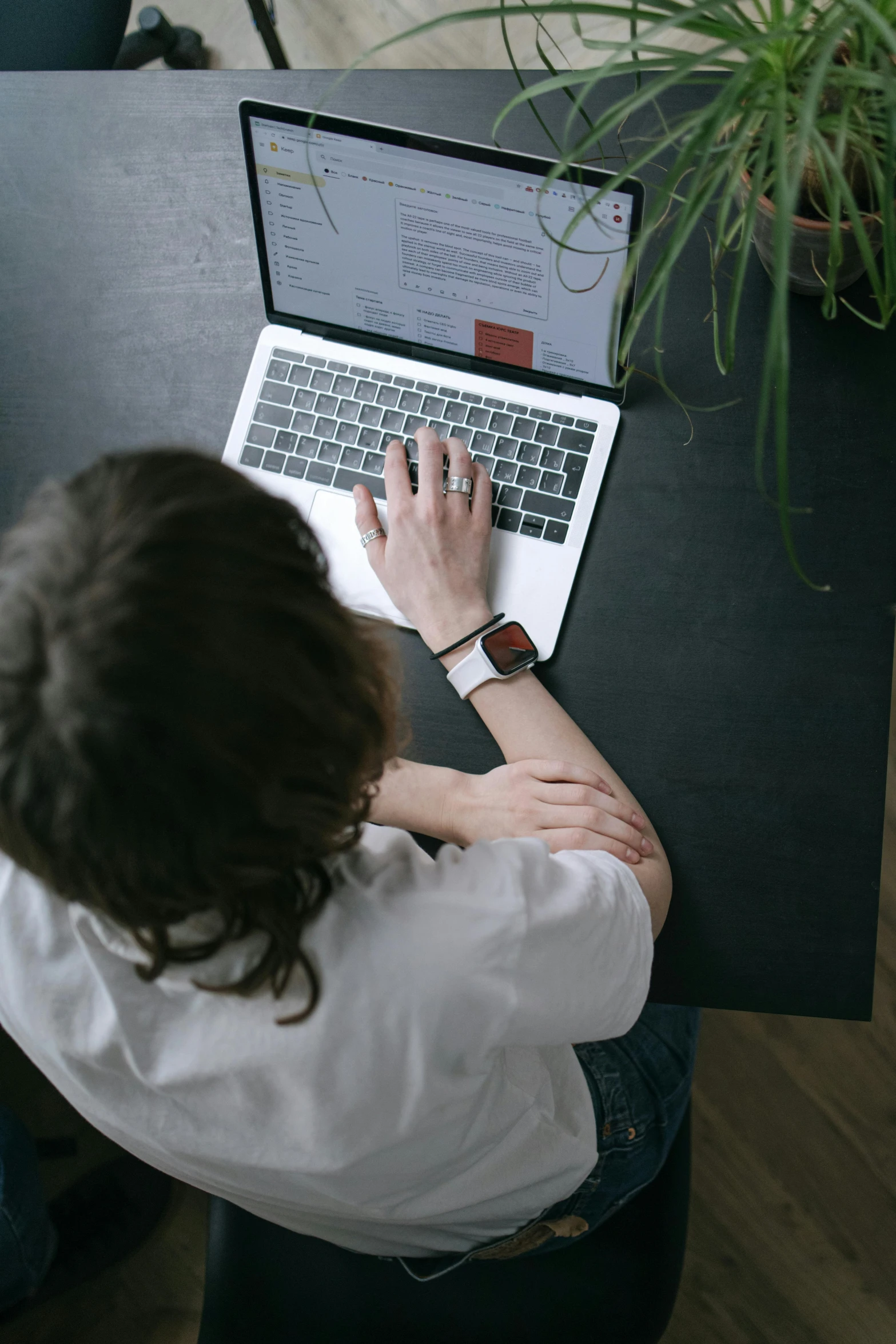 a woman sitting at a table using a laptop computer, trending on pexels, renaissance, top-down shot, man sitting facing away, professional photo, thumbnail