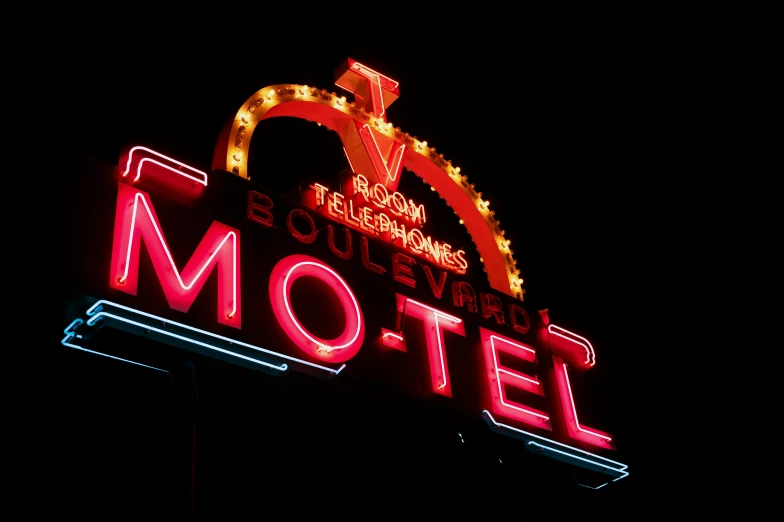 a neon sign for a motel lit up at night, an album cover, by Joe Bowler, pexels, art nouveau, dwell, moulin rouge, 1940s photo, yeg