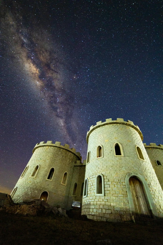 a castle at night with the milky in the background, by Peter Churcher, galaxies in the sky, byzantine, super wide, top