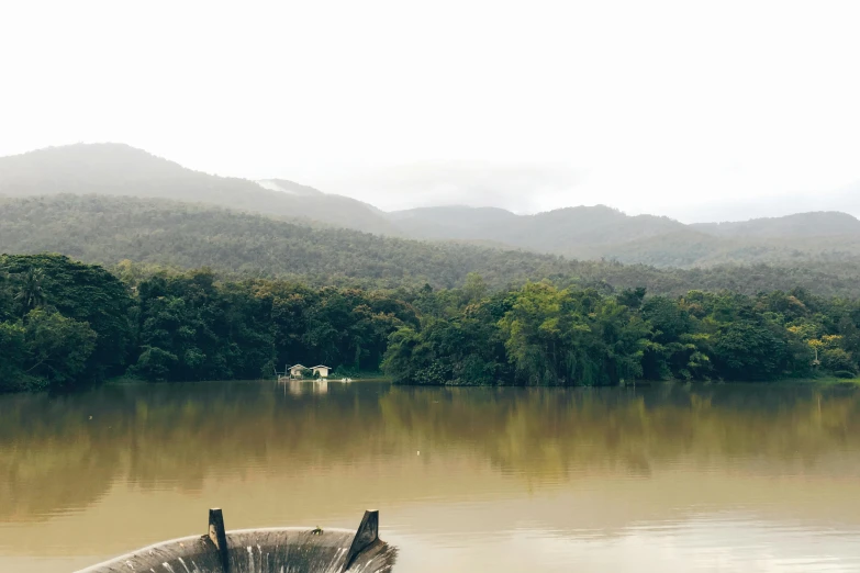a boat that is sitting in the water, a photo, inspired by Edwin Deakin, trending on unsplash, hurufiyya, rainforest mountains, water reservoir, tamborine, overflowing