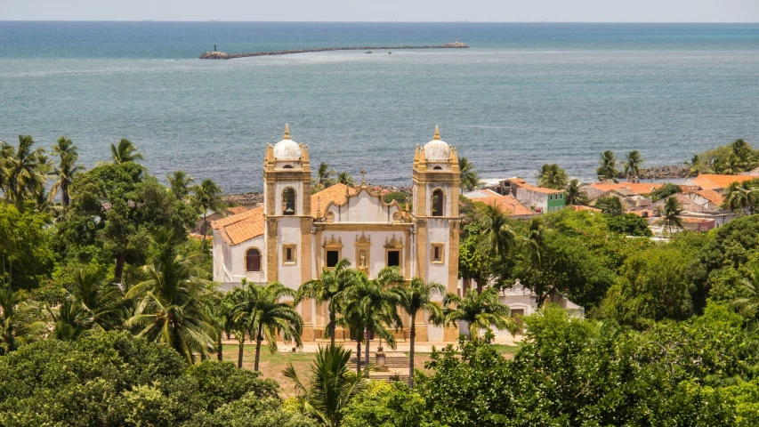 a church sitting on top of a lush green hillside, renaissance, tropical coastal city, profile image, azulejo, conde nast traveler photo