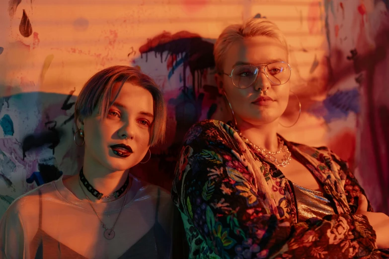 a couple of women standing next to each other, an album cover, inspired by Elsa Bleda, trending on pexels, realism, florence pugh, neon lenses for eyes, bleached, jewelry