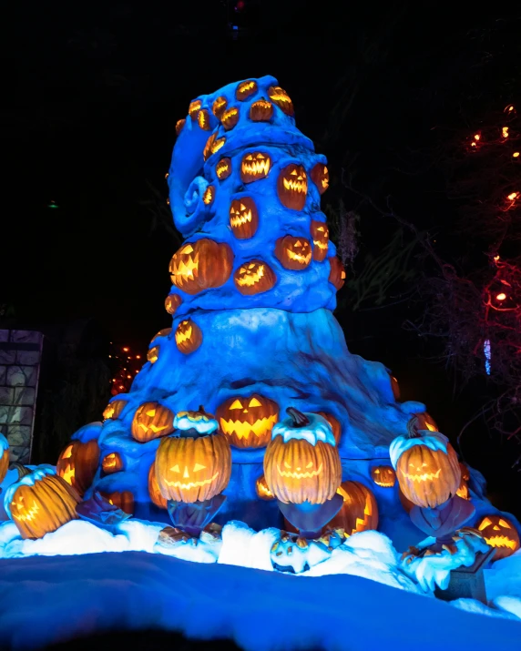 a group of carved pumpkins sitting on top of a snow covered hill, enchanted forest tower, a 15 foot tall, profile image, cold blue lighting