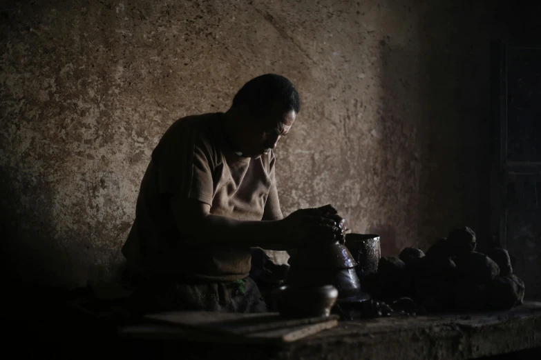 a man is making pottery in a dark room, inspired by Afewerk Tekle, mr robert is drinking fresh tea, photograph, illustration, thumbnail