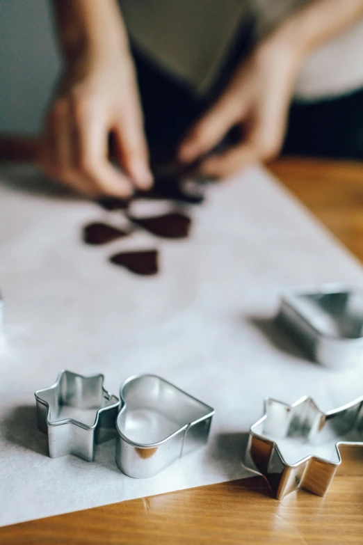 a close up of some cookie cutters on a table, inspired by david rubín, pexels, process art, partially cupping her hands, cooking, ornament, thumbnail