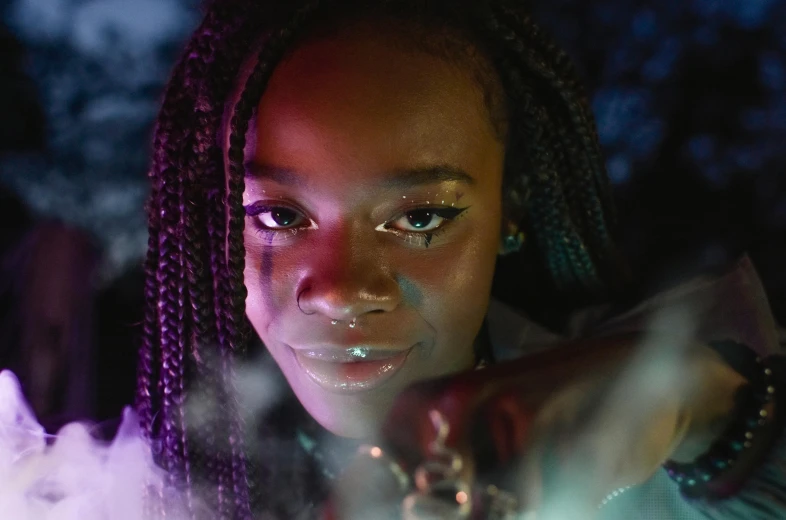 a close up of a person holding a cell phone, pexels contest winner, afrofuturism, police lights shine on her face, black teenage girl, photo from a promo shoot, ☁🌪🌙👩🏾