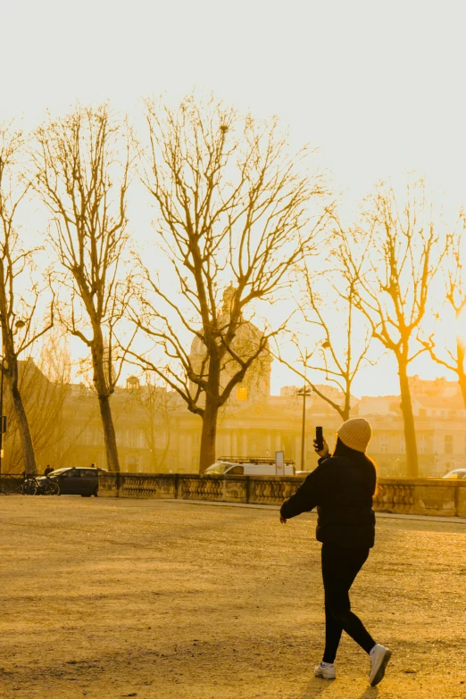 a person is flying a kite in a park, by Sven Erixson, pexels contest winner, visual art, the vatican, at sunrise in springtime, smartphone footage, shades of yellow