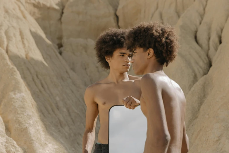 a couple of young men standing next to each other, trending on pexels, surrealism, brown skin like soil, with a mirror, loin cloth, 14 yo berber boy