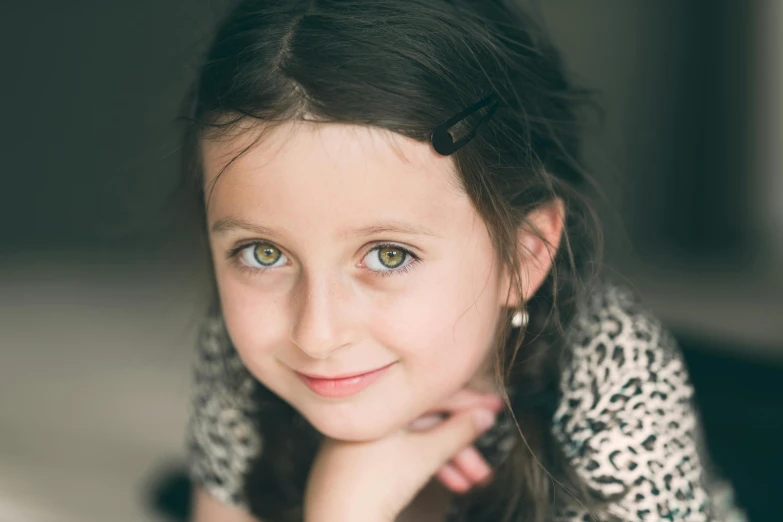 a little girl laying on top of a bed, a character portrait, pexels contest winner, hurufiyya, green eyes fine face pretty face, portrait. 8 k high definition, lachlan bailey, small and sharp pupils