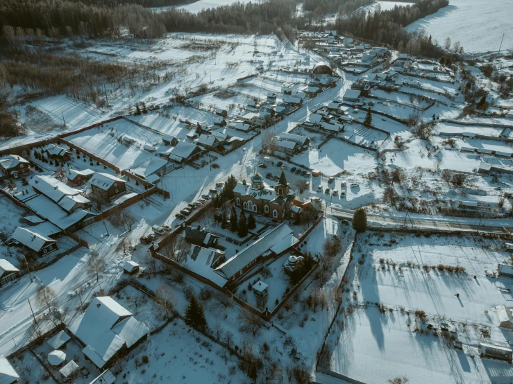 an aerial view of a village covered in snow, by Adam Marczyński, pexels contest winner, hurufiyya, ancient russian architecture, thumbnail, low - angle shot, pov photo