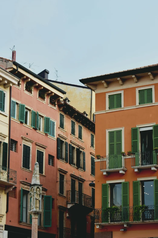 a couple of buildings that are next to each other, inspired by Carlo Maderna, pexels contest winner, renaissance, airy colors, bizzaro, downtown, colorful”