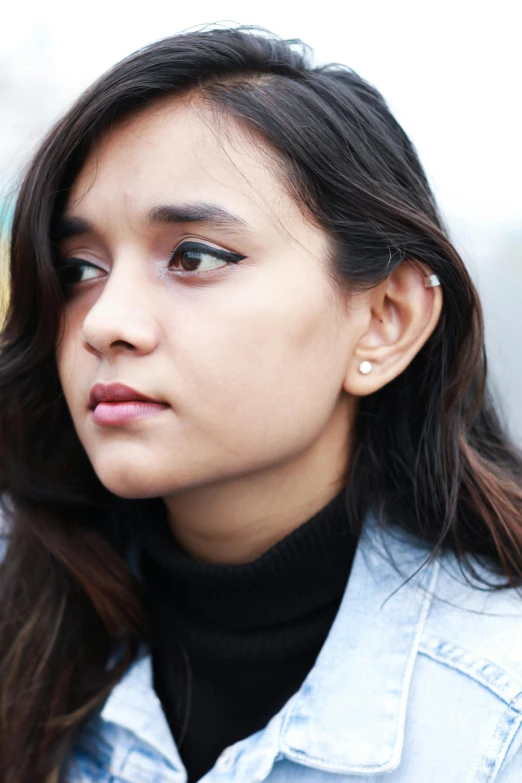 a woman with long hair wearing a denim jacket, inspired by Sasha Putrya, earring, wearing a black jacket, thoughtful expression, gemma chen