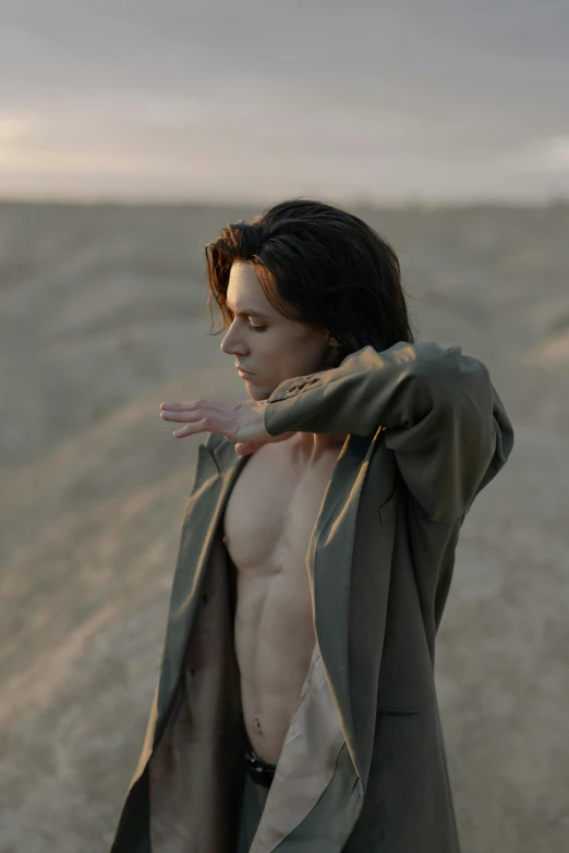 a man standing in the middle of a dirt road, an album cover, unsplash contest winner, renaissance, attractive androgynous humanoid, jacket over bare torso, levi ackerman, still from a music video