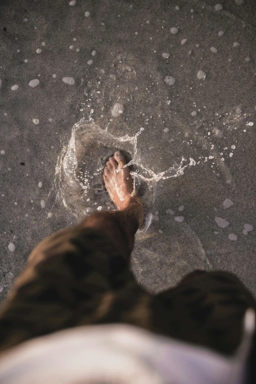 a person standing in the water with their feet in the water, trending on unsplash, dusty dirty floor, pouring, ignant, drops around