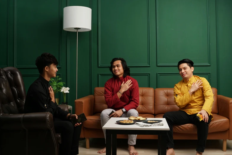 a couple of men sitting on top of a couch, inspired by Pál Balkay, pexels, dau-al-set, 3 actors on stage, set on singaporean aesthetic, ready to eat, background image