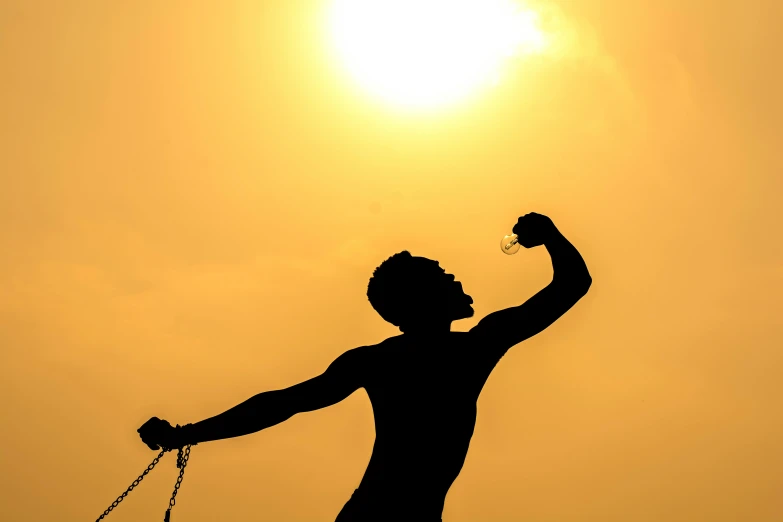 a silhouette of a man with a chain around his neck, pexels contest winner, figuration libre, having fun in the sun, depressed dramatic bicep pose, photo from the olympic games, sun overhead